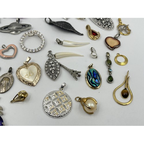 1231E - A collection of pendants and charms