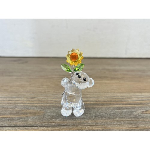 208 - A boxed Swarovski Crystal teddy bear with flower figurine - approx. 6cm high