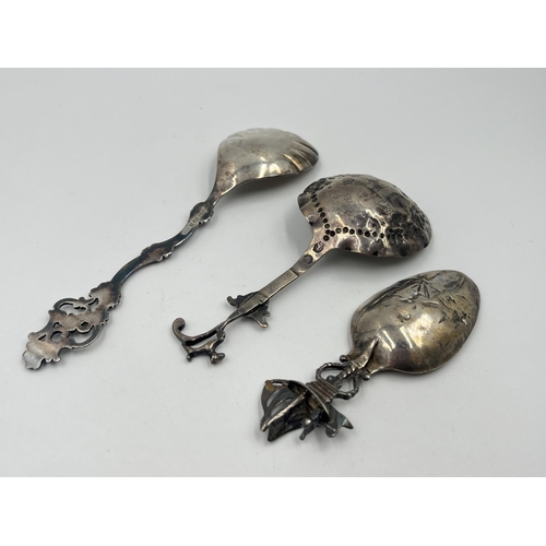 1253 - Three silver collector's spoons, one .925 with windmill and nautical scene, one .830 and one Dutch .... 