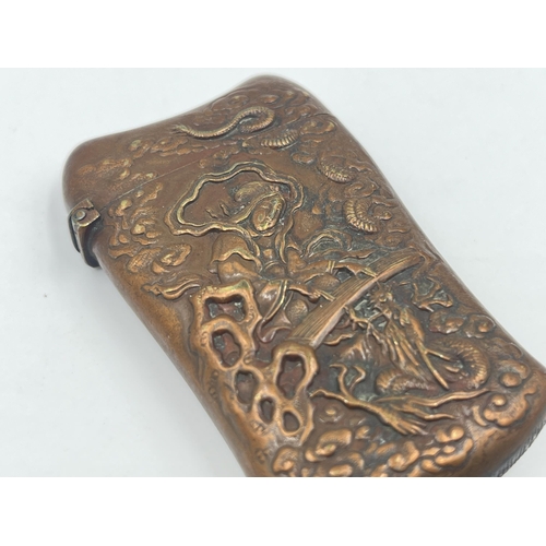 1344A - A 19th century Oriental embossed copper vesta case - approx. 6cm high x 4cm wide