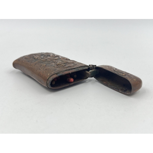 1344A - A 19th century Oriental embossed copper vesta case - approx. 6cm high x 4cm wide