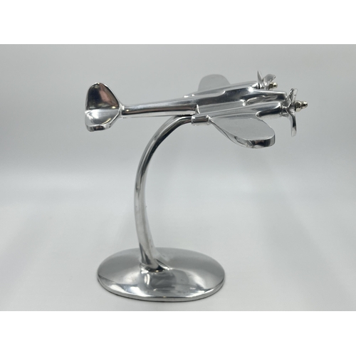 1347 - An aluminium desk model of an aircraft - approx. 20cm high x 21.5cm wide