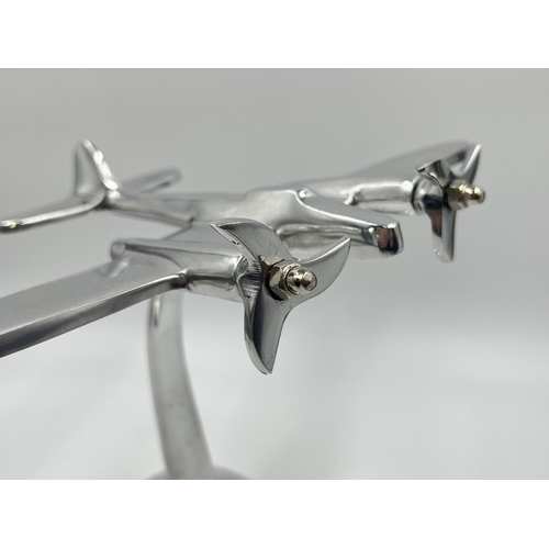 1347 - An aluminium desk model of an aircraft - approx. 20cm high x 21.5cm wide