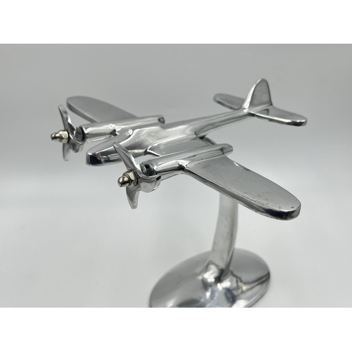 1347 - An aluminium desk model of an aircraft - approx. 20cm high x 21.5cm wide