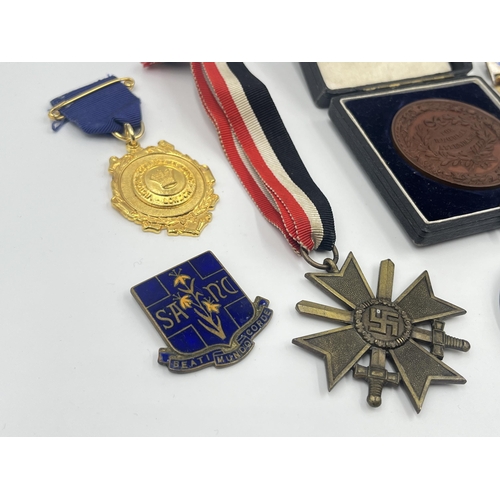 1386 - A collection of medals and badges to include Royal Masonic Institution for Girls, German War Merit C... 