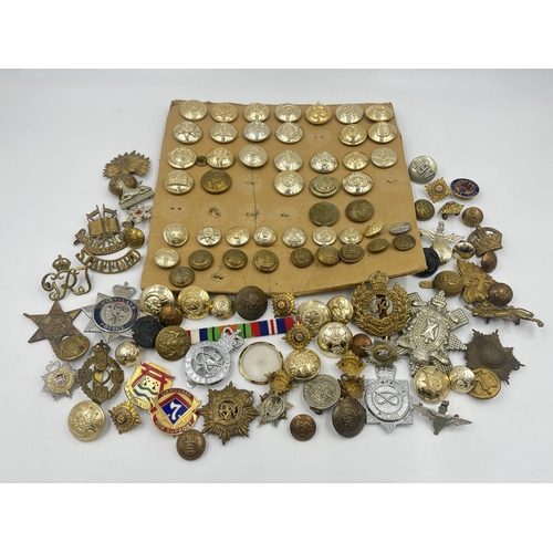 1387 - A collection of military buttons and cap badges to include The Royal Highlanders Blackwatch, Royal E... 