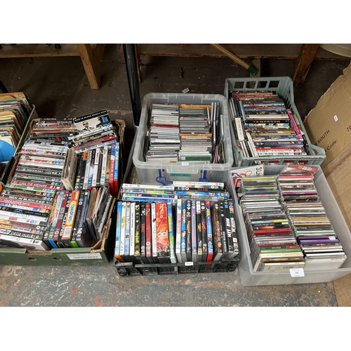 740 - Ten boxes containing a large collection of DVDs, CDs and vinyls