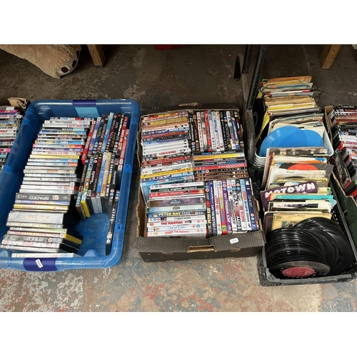 740 - Ten boxes containing a large collection of DVDs, CDs and vinyls