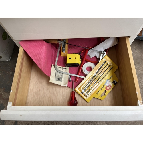 747 - A box and a white painted chest of drawers with contents to include stationary, tools etc.