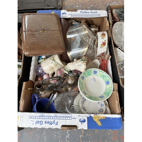 791 - Nine boxes containing lamps, vintage tennis racket, tambourine, glassware, cased cutlery and ceramic... 