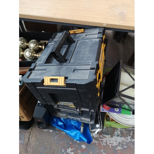 749 - A large collection of house clearance items to include DeWalt stack tool box, PlayStation games, DVD... 