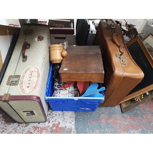 753 - A collection of house clearance items to include boxed Iron Gym workout bar, vintage annuals, luggag... 