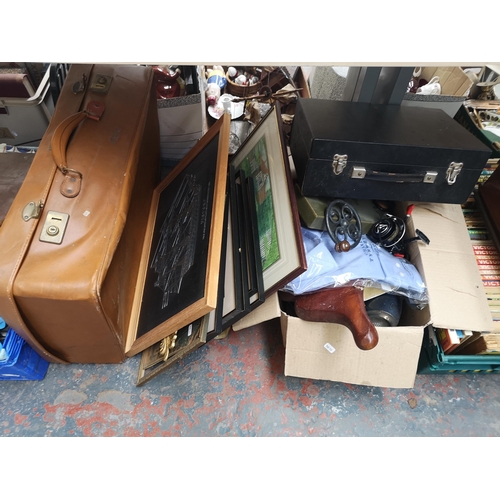 753 - A collection of house clearance items to include boxed Iron Gym workout bar, vintage annuals, luggag... 