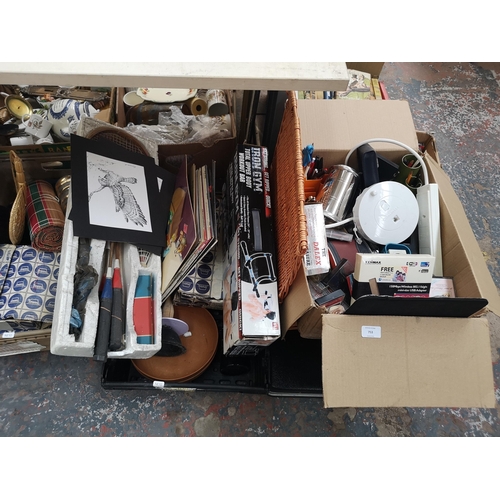 753 - A collection of house clearance items to include boxed Iron Gym workout bar, vintage annuals, luggag... 