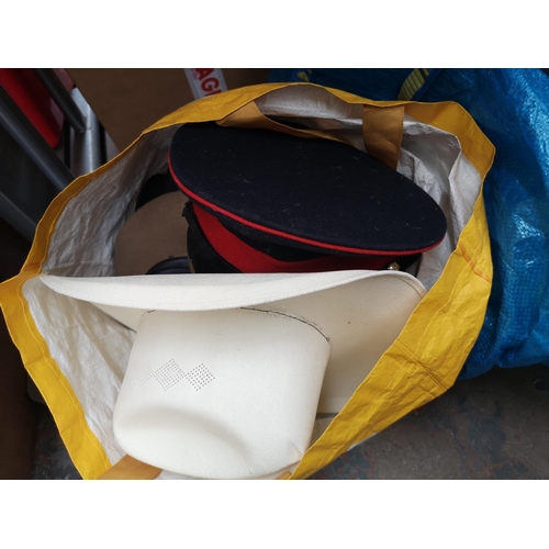 766 - Three boxes and two bags containing books, ceramics, hats and photography equipment