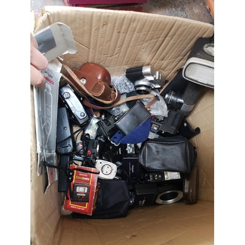 766 - Three boxes and two bags containing books, ceramics, hats and photography equipment