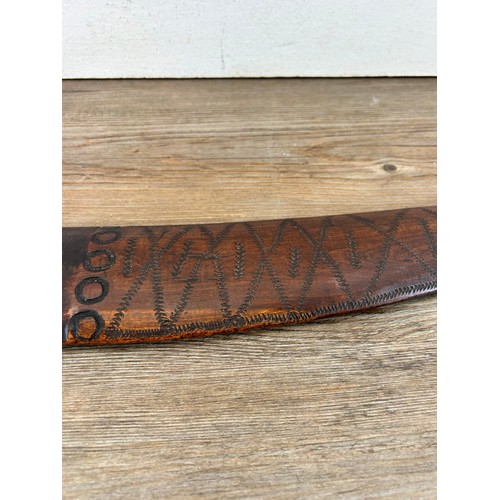 419 - Two pieces of late 19th/early 20th century aboriginal ephemera, carved boomerang and bow