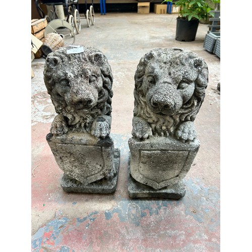 732 - A pair of cast stone heraldic lion garden statues - approx. 48cm high x 18cm wide x 20cm deep