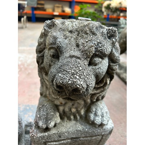 732 - A pair of cast stone heraldic lion garden statues - approx. 48cm high x 18cm wide x 20cm deep