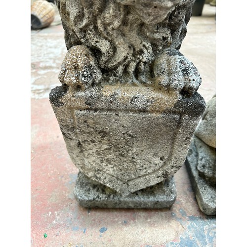 732 - A pair of cast stone heraldic lion garden statues - approx. 48cm high x 18cm wide x 20cm deep