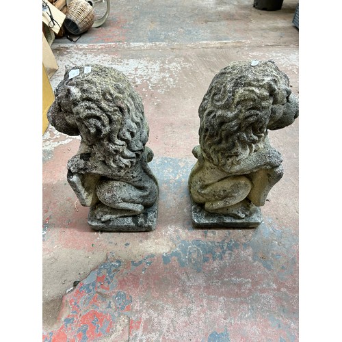 732 - A pair of cast stone heraldic lion garden statues - approx. 48cm high x 18cm wide x 20cm deep