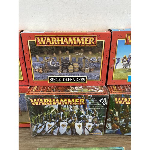 336 - A collection of Warhammer figurines to include High Elf Silver Helms, Siege Defenders, Siege Attacke... 