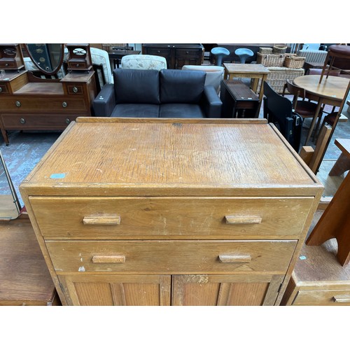 109 - A 1940s oak tall boy with two drawers and two cupboard doors - approx. 123cm high x 83.5cm wide x 47... 