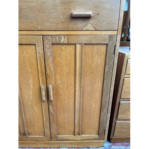 109 - A 1940s oak tall boy with two drawers and two cupboard doors - approx. 123cm high x 83.5cm wide x 47... 