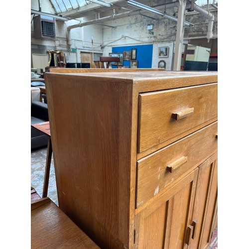 109 - A 1940s oak tall boy with two drawers and two cupboard doors - approx. 123cm high x 83.5cm wide x 47... 