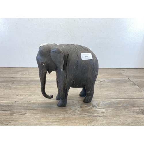 690 - A late 19th/early 20th century carved and ebonised elephant figurine - approx. 23cm high x 21cm long