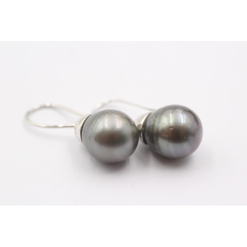 1006 - A pair of 9ct white gold black pearl drop earrings - approx. gross weight 8.7 grams