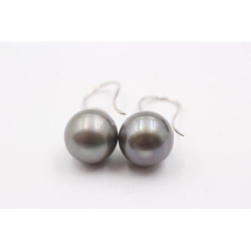 1006 - A pair of 9ct white gold black pearl drop earrings - approx. gross weight 8.7 grams