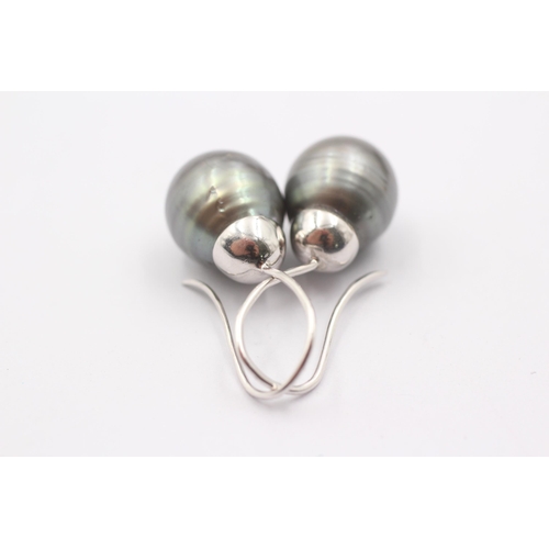 1006 - A pair of 9ct white gold black pearl drop earrings - approx. gross weight 8.7 grams