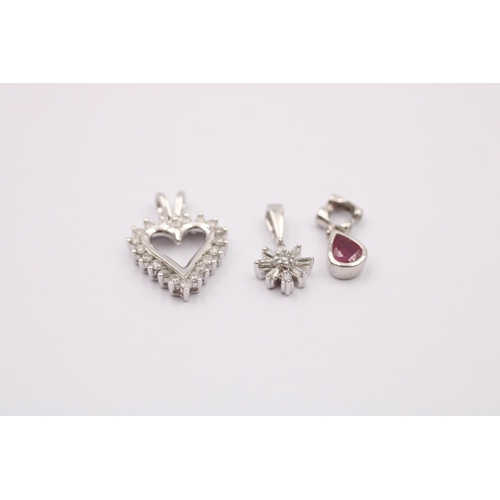 1012 - Three 9ct white gold diamond set pendants, one with ruby - approx. gross weight 2.4 grams