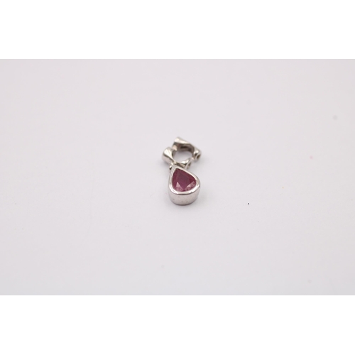 1012 - Three 9ct white gold diamond set pendants, one with ruby - approx. gross weight 2.4 grams