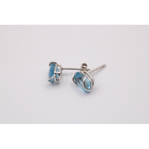 1013 - Two pairs of 9ct gold topaz earrings, one white gold and one yellow gold with diamonds - approx. gro... 