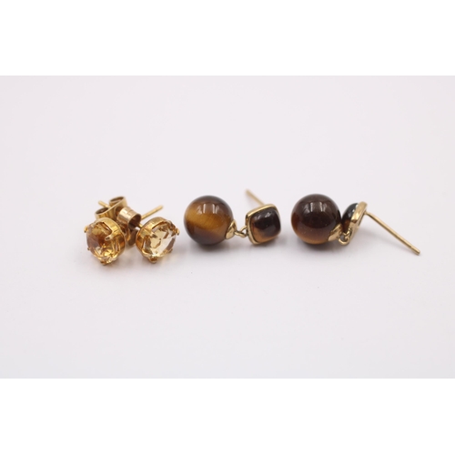 1014 - Two pairs of 9ct gold gemstone earrings, one tigers eye and one citrine - approx. gross weight 3.5