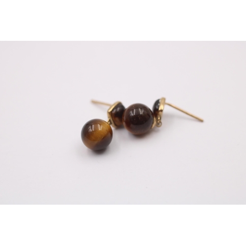 1014 - Two pairs of 9ct gold gemstone earrings, one tigers eye and one citrine - approx. gross weight 3.5