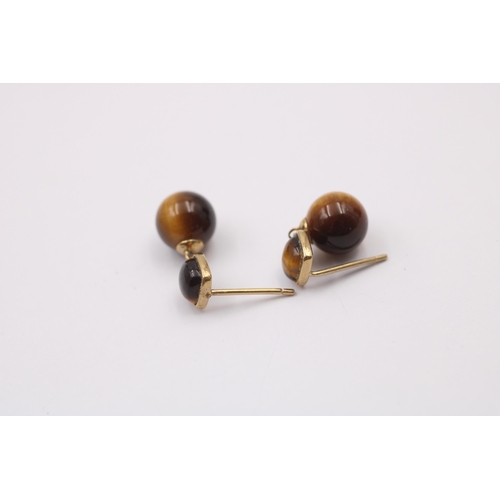 1014 - Two pairs of 9ct gold gemstone earrings, one tigers eye and one citrine - approx. gross weight 3.5