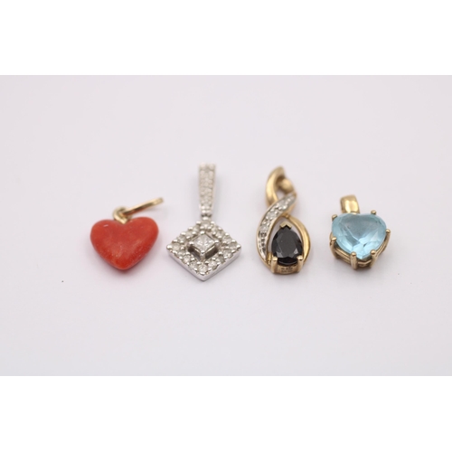 1015 - Four 9ct gold pendants, one diamond, one coral, one sapphire and diamond and one topaz - approx. gro... 