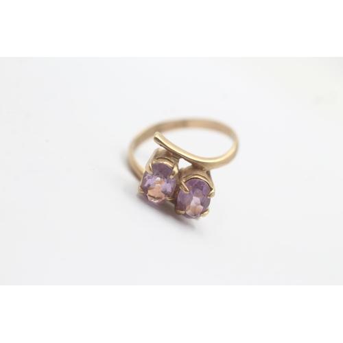 1080 - A 9ct gold amethyst Toi et Moi two stone bypass ring - approx. gross weight 2.6 grams