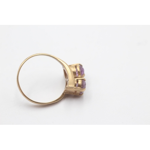 1080 - A 9ct gold amethyst Toi et Moi two stone bypass ring - approx. gross weight 2.6 grams