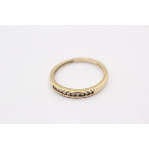 1111 - A 9ct gold channel set diamond ring - approx. gross weight 1.2 grams