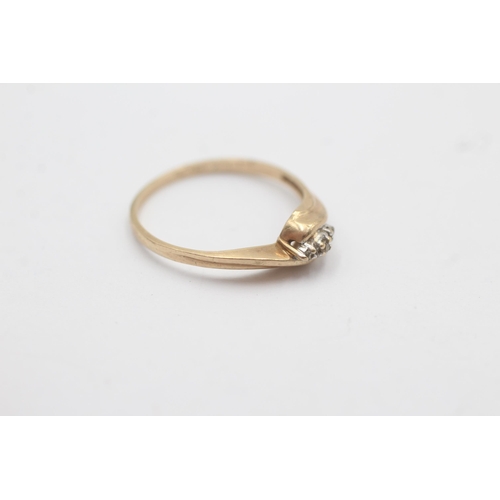 1131 - A 9ct white and yellow gold diamond trilogy bypass ring - approx. gross weight 1.2 grams