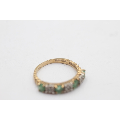 1134 - A 9ct gold diamond and emerald seven stone ring - approx. gross weight 2.1 grams