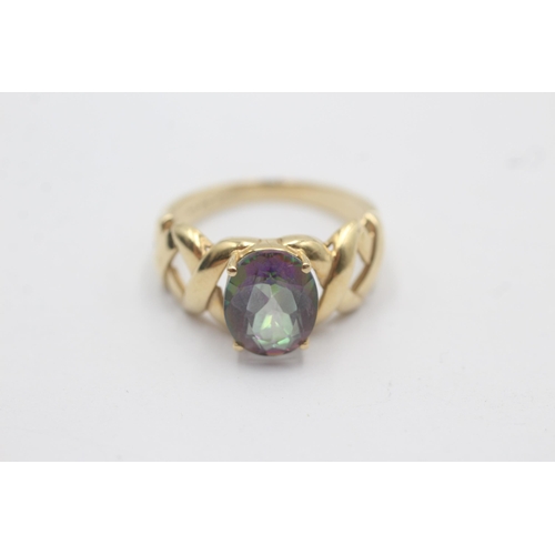 1143 - A 9ct gold oval mystic topaz solitaire ring with openwork shoulder detail - approx. gross weight 3.4... 