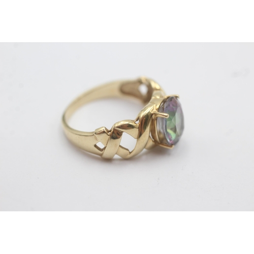 1143 - A 9ct gold oval mystic topaz solitaire ring with openwork shoulder detail - approx. gross weight 3.4... 