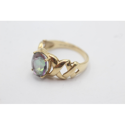 1143 - A 9ct gold oval mystic topaz solitaire ring with openwork shoulder detail - approx. gross weight 3.4... 