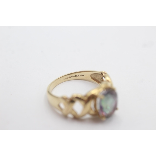 1143 - A 9ct gold oval mystic topaz solitaire ring with openwork shoulder detail - approx. gross weight 3.4... 