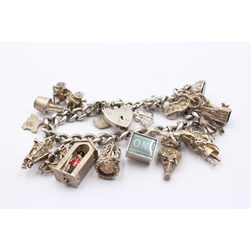 1151 - A .925 silver charm bracelet with assorted charms